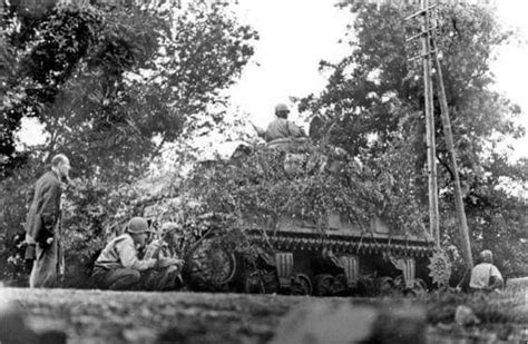 A Member Of The French Resistance And Several Tank Crews Take Cover