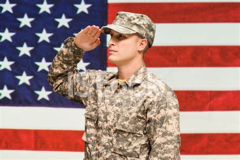 Army Man In Front Of American Flag And Saluting Stock Photo Royalty