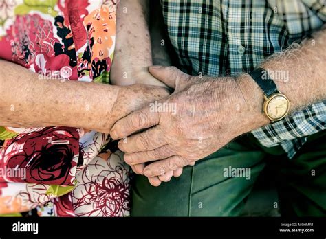 Hands Of Elderly Couple Holding Hands Of Seniors Together Close Up