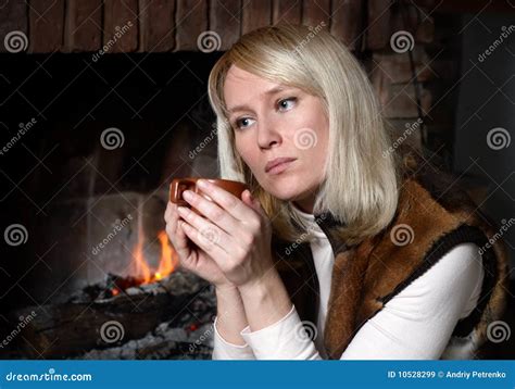 Beautiful Woman With A Mug Near A Fireplace Stock Image Image Of