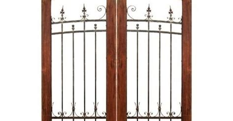 Curved Double Wooden Gate With Wrought Iron Inserts And Salvaged Wood