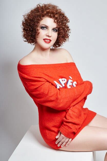 Premium Photo Curly Redhead Adult Sexy Woman In Red Sweater