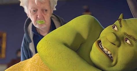 An Older Woman Is Brushing Her Teeth Next To A Green Man In The Movie
