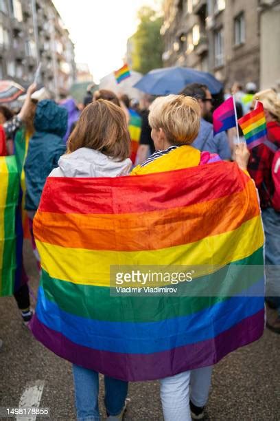 gay pride flag couple photos and premium high res pictures getty images
