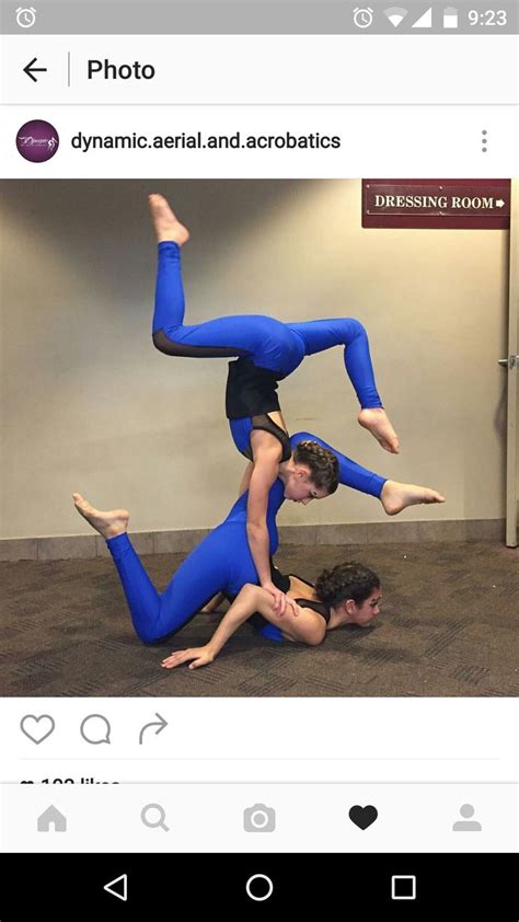 Two People Doing Acrobatics On The Floor With One Person Upside Down In