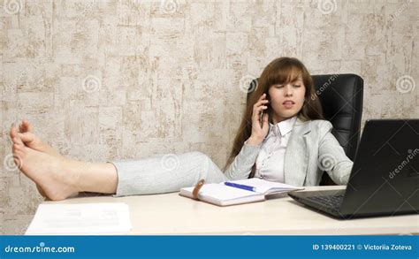 Beautiful Business Woman Sitting In Chair With Bare Feet On Table Girl