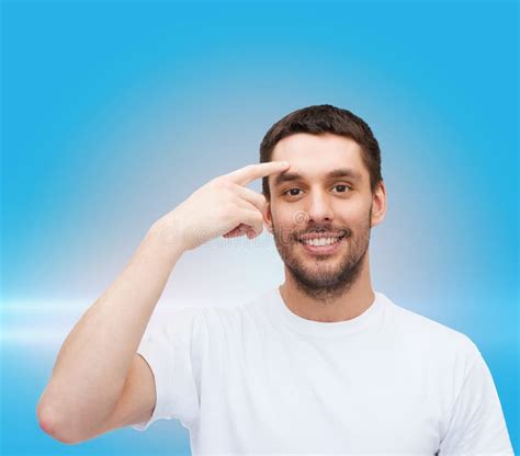 Smiling Young Handsome Man Pointing To Forehead Stock Photo Image Of