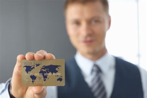 Premium Photo Businessman Holds A Credit Bank Card Closeup