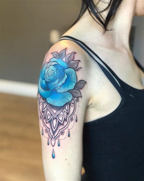 A Woman With A Blue Rose Tattoo On Her Arm
