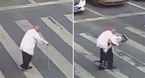 watch traffic police helps elderly man cross the road by lifting him on his back