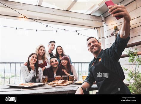 Happy Group Of Friends Drinking Beer And Take A Selfie At Brewery Bar