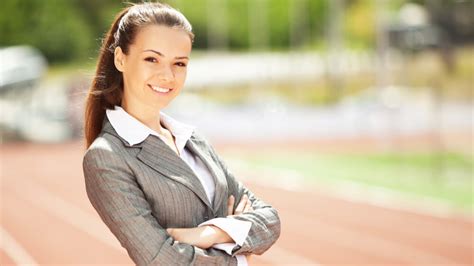 Young Professional In Business Attire Smiles In Confident Pose On Track