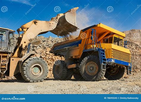 Wheel Loader Loading Ore Into Dump Truck At Opencast Stock Image