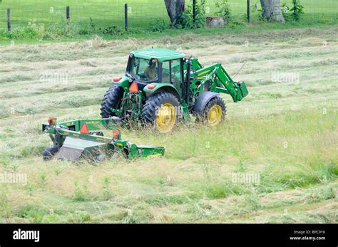 Tractor Cutting Hay In A Field In Kentucky Usa Stock Photo Alamy