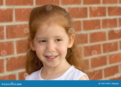 Retrato Da Menina Nova Do Miúdo Do Redhead Pela Parede De Tijolo Imagem De Stock Imagem De