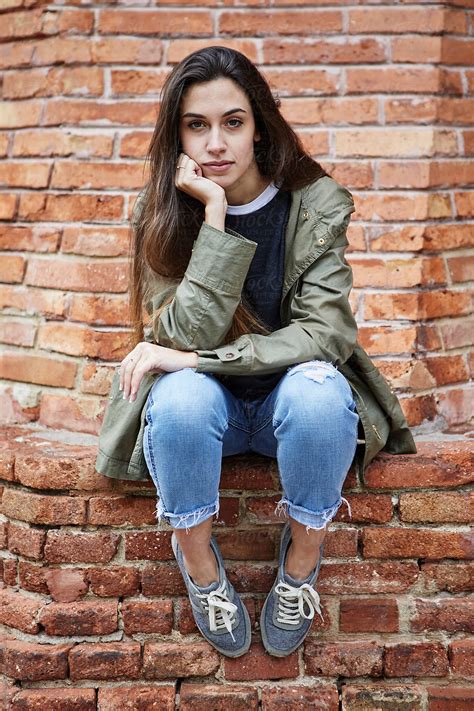 Long Haired Girl Looking At Camera With Hand At Face By Stocksy Contributor Guille Faingold