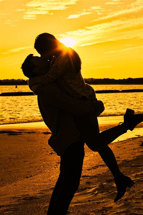 Engaged Couple Kiss At Golden Sunset On The Beach Couple Beach