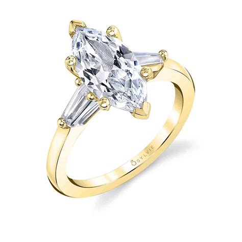Its unique presence commands attention and its elongated is known to flatter the wearer by making the finger appear longer and slimmer. Three Stone Marquise Engagement Ring with Baguettes - Nicolette