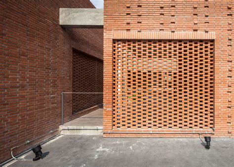Brick grates set into the walls of a Bangkok house hide a ...