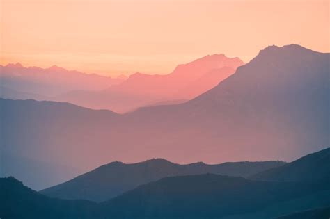 Premium Photo Mountain Range In Pink Sunlight At Sunset Blue