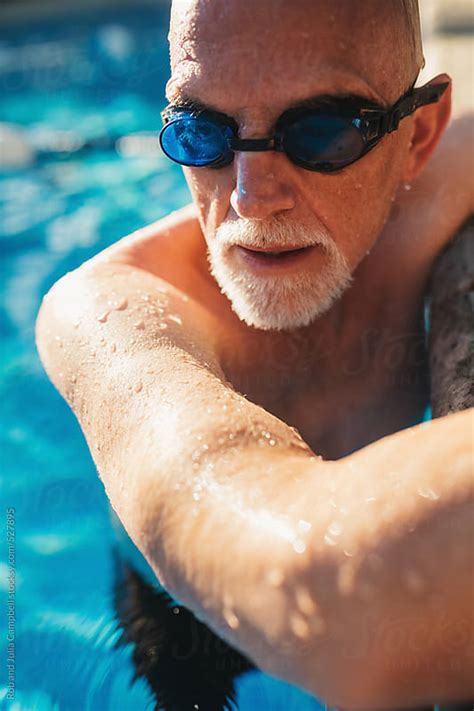 Active Older Man Working Out In Outdoor Swimming Pool By Rob And Julia