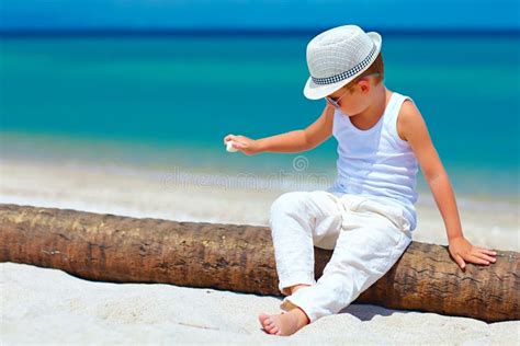 Cute Fashionable Kid Boy Playing With Shell On Tropical Beach Stock