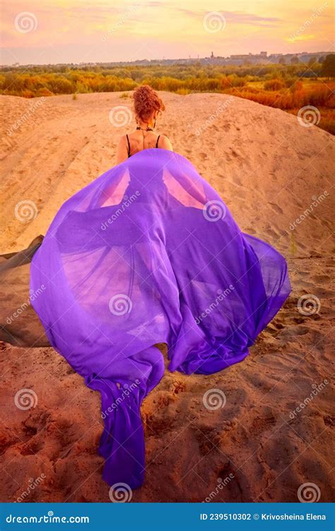 Beautiful Girl With Black Dress And Violet Fluttering Cloth Dancing On