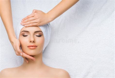 Young And Healthy Woman Gets Massage Treatments For Face Skin And Neck