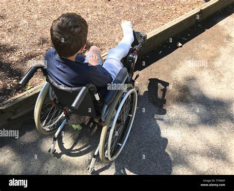 Boy With Broken Leg Sitting In The Wheelchair Stock Photo Alamy
