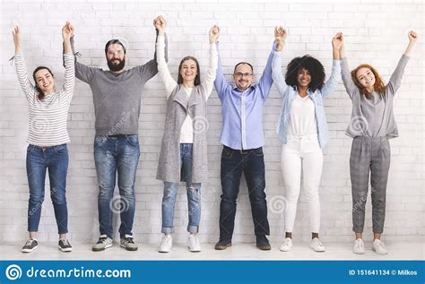 Group Of Successful Friendly People Raising Connected Hands Stock Photo ...