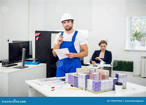 Young Construction Supervisor Taking Notes In The Office Stock Photo