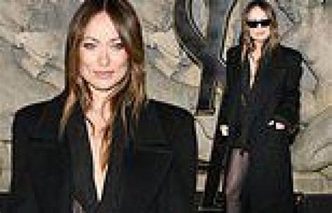 Olivia Wilde Stuns In A Plunging Black Dress Under A Long Coat At The