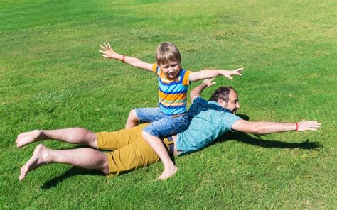 Dad And Son Rest On Grass On Sunny Summer Day Stock Image Image Of