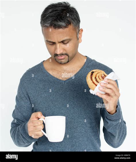 Adult Man Holding Mug And Bread Roll Stock Photo Alamy