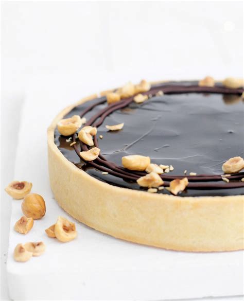 There Is A Chocolate Cake With Nuts On Top