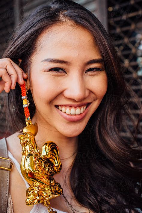 Woman Holding Up Golden Rooster For Chinese New Year Del Colaborador