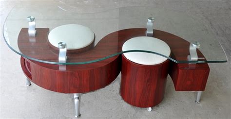 Displaying a softly distressed and reclaimed table top, this wood coffee table is set on gunmetal finished legs, creating an alluring natural look. S-shaped Dontai glass top coffee table and 2 stools in ...
