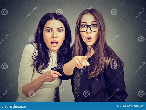 Two Young Shocked Women Are Scared About Something Pointing Fingers At Camera Stock Image