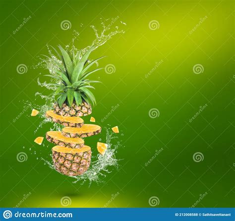 Water Splash On Fresh Pineapple Isolated On Green Background Stock