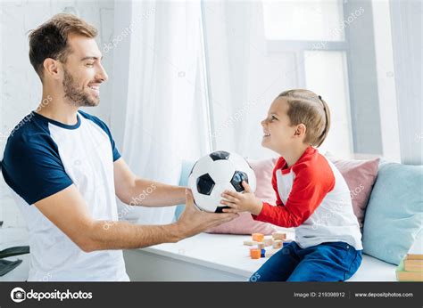 Cheerful Man Son Football Ball Home — Stock Photo © Igorvetushko 219398912