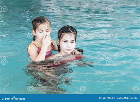 Two Girls Swim In The Pool Two Sisters In The Pool Two Happy Girls