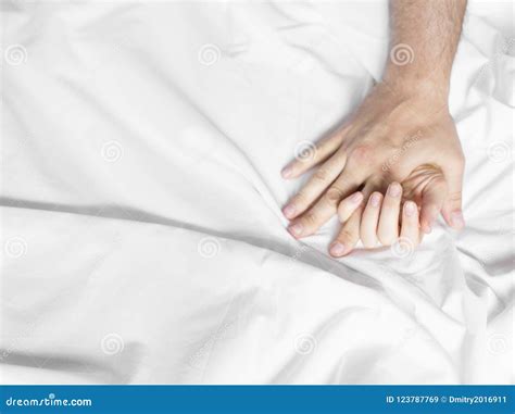 Couple Hands Pulling White Sheets In Ecstasy Orgasm Concept Of