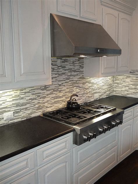Black Pearl Leather Granite Countertops With A Mosaic Backsplash And