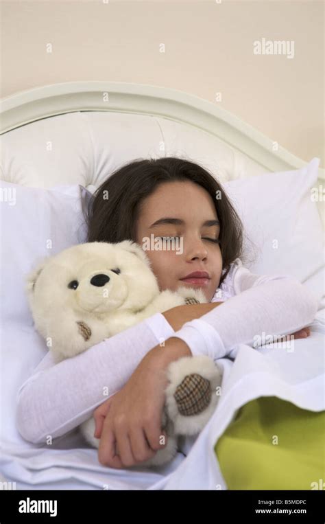 A Little Girl In Bed With A Teddy Bear Stock Photo Alamy