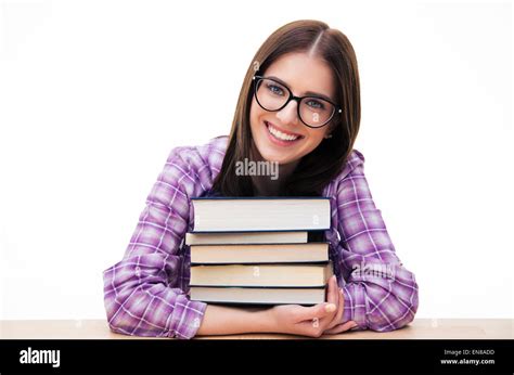 Happy Young Female Student Sitting At The Table With Books Over White