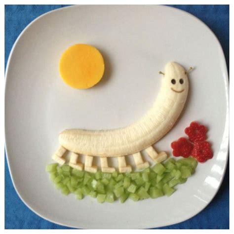 A White Plate Topped With Fruit And A Banana Shaped Like A Smile On Top