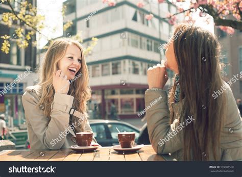 Two Young Women Talk Drink Coffee Stock Photo 139608560