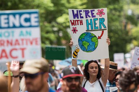 Woman Holds Up Sign Marching At Atlanta Earth Day March Editorial