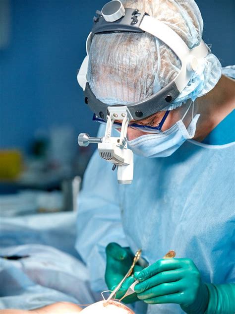 Premium Photo Surgeon Doctor Wearing Protective Mask And Hat During
