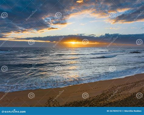 Sunrise Over The Ocean With Clouds And Sunburst Stock Photo Image Of